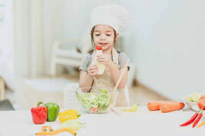 Woman holding ice cream in bowl on table