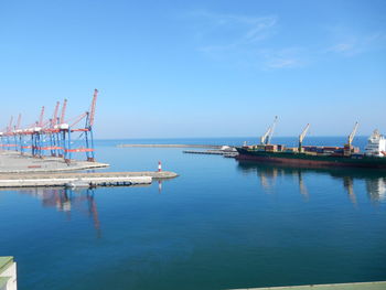 Scenic view of ship at harbor against clear sky