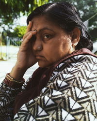 Close-up portrait of woman with head in hands