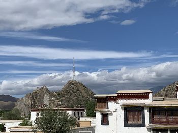 Panoramic view of buildings and mountains against sky