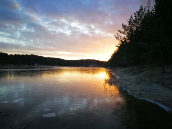 Scenic view of lake against sky at sunset
