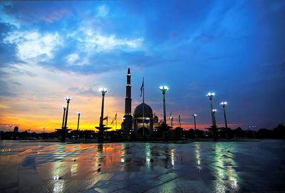 View of illuminated building against sky during sunset