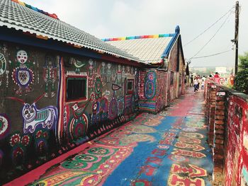 Graffiti on wall of building against sky
