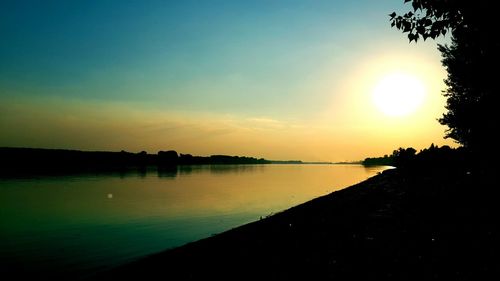 Scenic view of lake against sky during sunset