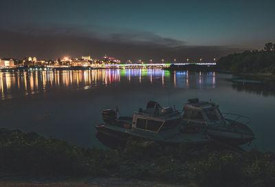 Scenic view of lake against sky at night