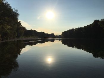 Scenic view of river against sky during sunset