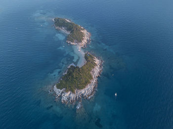 High angle view of rocks on sea shore