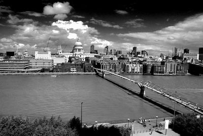 Buildings in city against cloudy sky