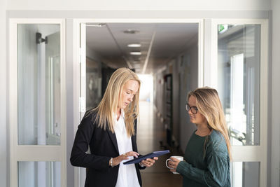 Coworkers talking on corridor