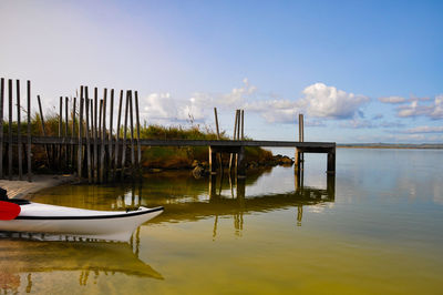 Pier on lake against sky