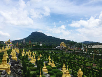 Panoramic view of trees and buildings against sky