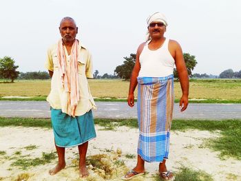 Full length of a young woman standing on field