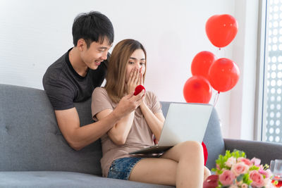 Young couple sitting on sofa