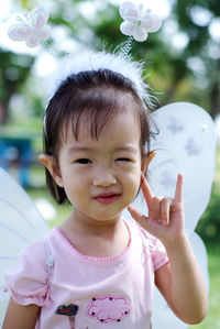 Close-up portrait of cute girl wearing angel costume