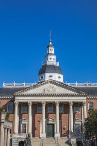 Low angle view of building against blue sky