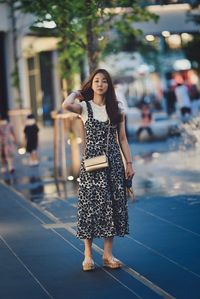 Portrait of young woman standing outdoors