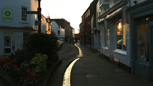 Empty road along buildings
