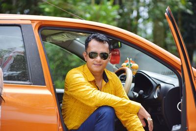 Portrait of mid adult man sitting in car