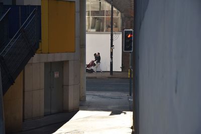 Man on street amidst buildings in city