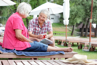 Rear view of people sitting outdoors