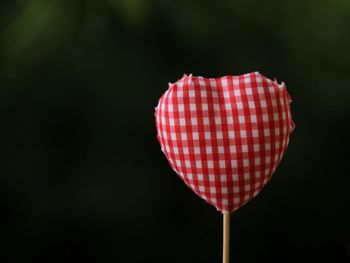 Close-up of red heart shape against gray background