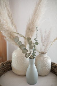 Close-up of white flower vase on table at home