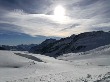 Scenic view of snow mountains against sky