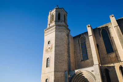 Low angle view of building against clear blue sky