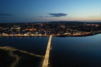 High angle view of illuminated buildings in city at night