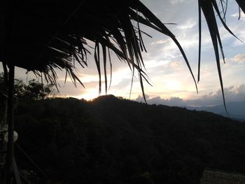 Scenic view of silhouette mountains against sky during sunset