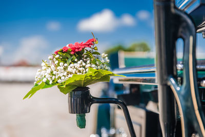 A small bouquet of flowers on a carriage.