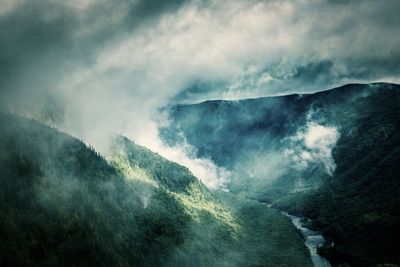 Scenic view of waterfall against sky