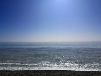 Scenic view of sea against clear blue sky