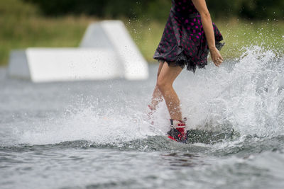 Low section of girl playing in water