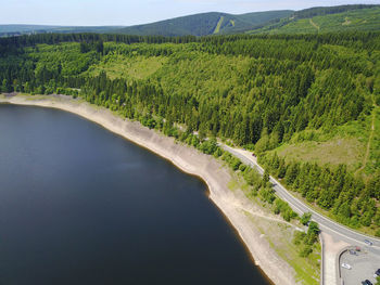 Scenic view of river by mountains against sky