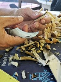 Close-up of hand holding bread on table