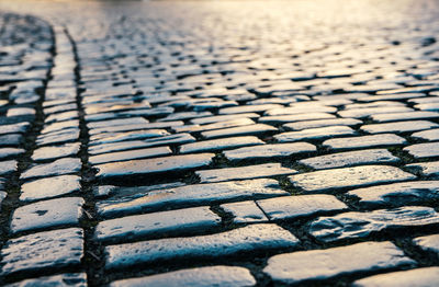 Surface level of cobbled street on sunny day