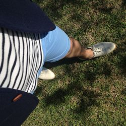 Low section of man relaxing on grassy field