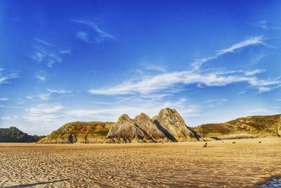 Scenic view of desert against blue sky