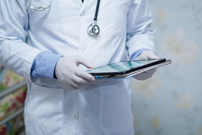 Midsection of man using mobile phone