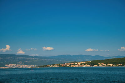 Scenic view of sea by city against sky