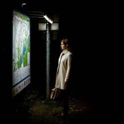 Full length of woman standing on wall