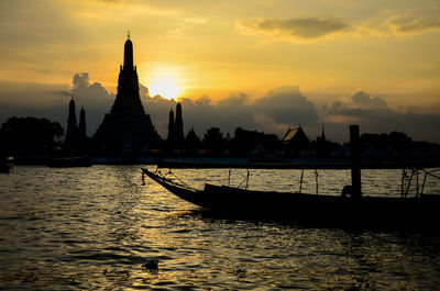 Silhouette of temple against sky during sunset