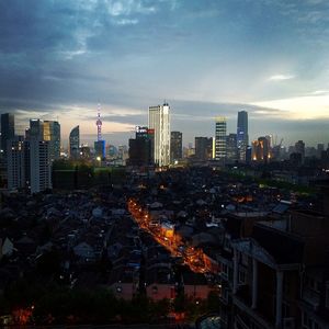 Illuminated cityscape against sky