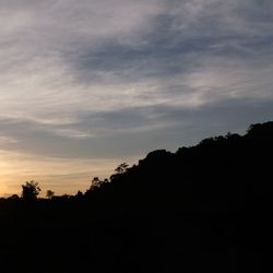 Low angle view of silhouette trees against sky at sunset