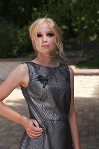 Portrait of beautiful young woman standing at park