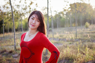 Portrait of beautiful young woman standing outdoors