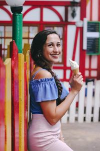 Portrait of a smiling young woman standing outdoors