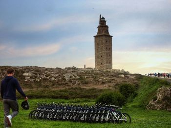 People in front of tower against sky