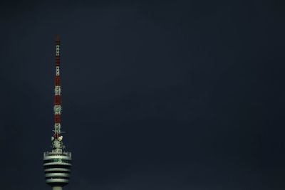 Communications tower against sky at night